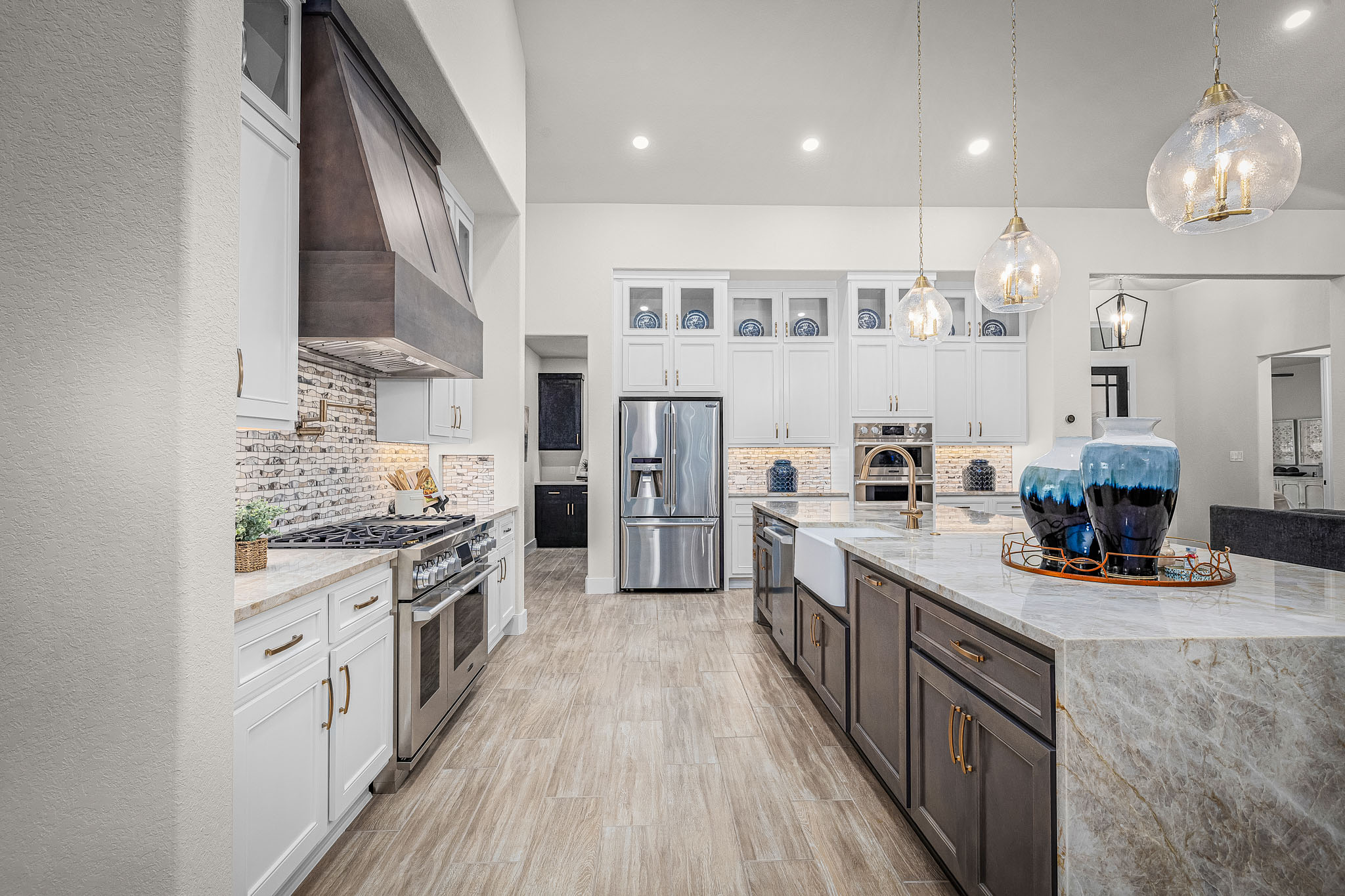 Custom kitchen with marble island and brass fixtures — Hearthside Homes